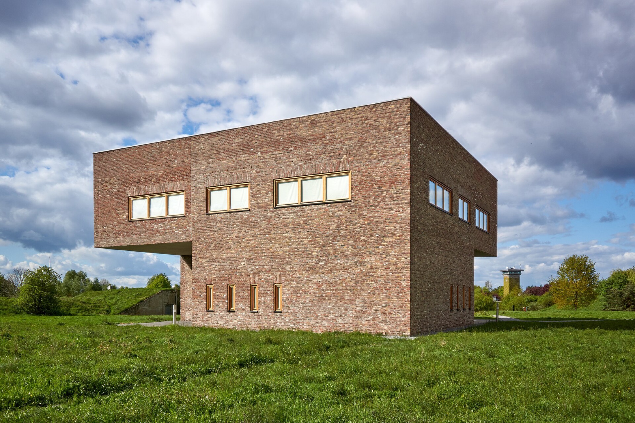 Reading House, a small brick library lifted off the ground and open to the meadow