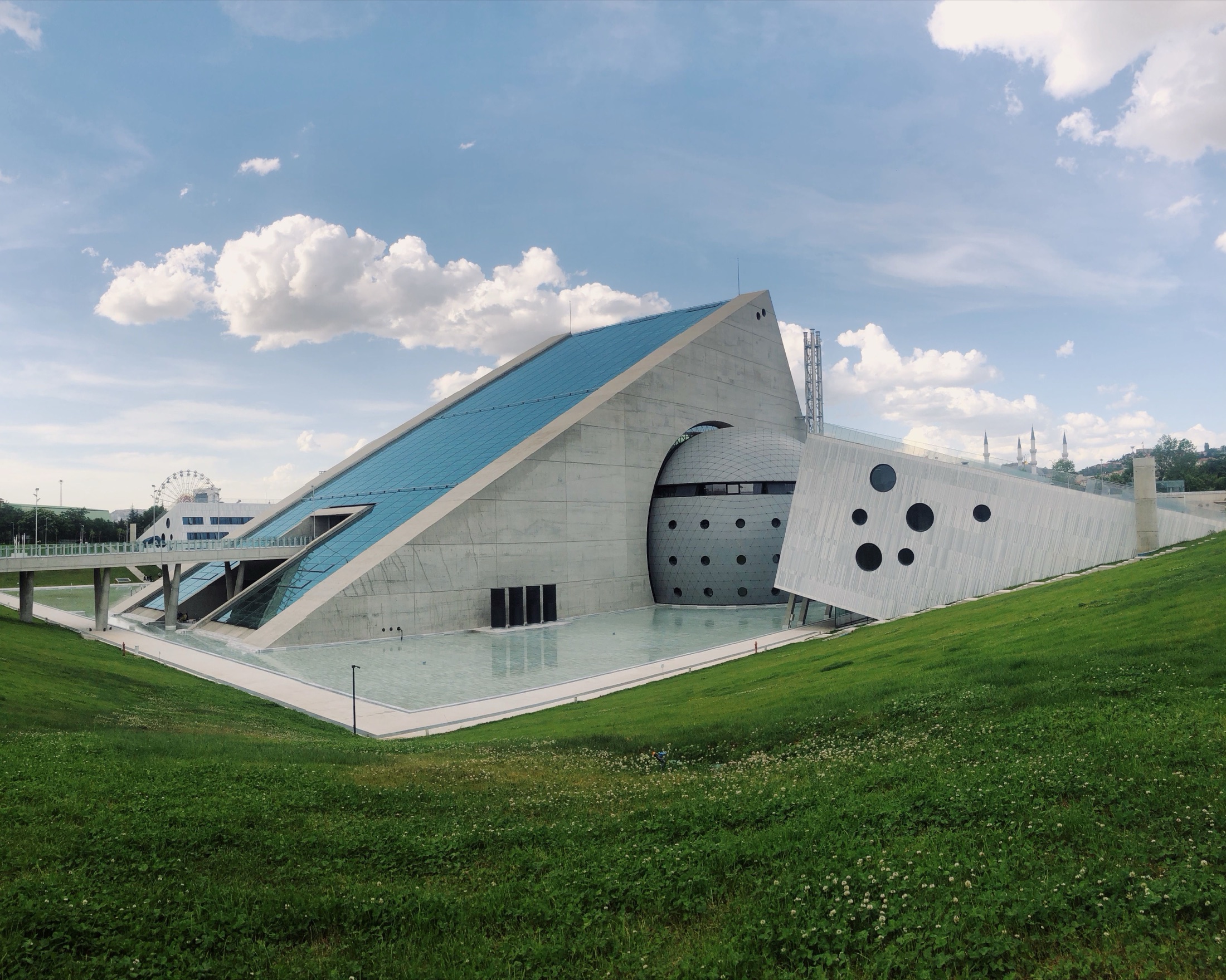 Nightfall Gallery, a concrete wedge with a faceted sphere pushing through its face, above a reflecting pool